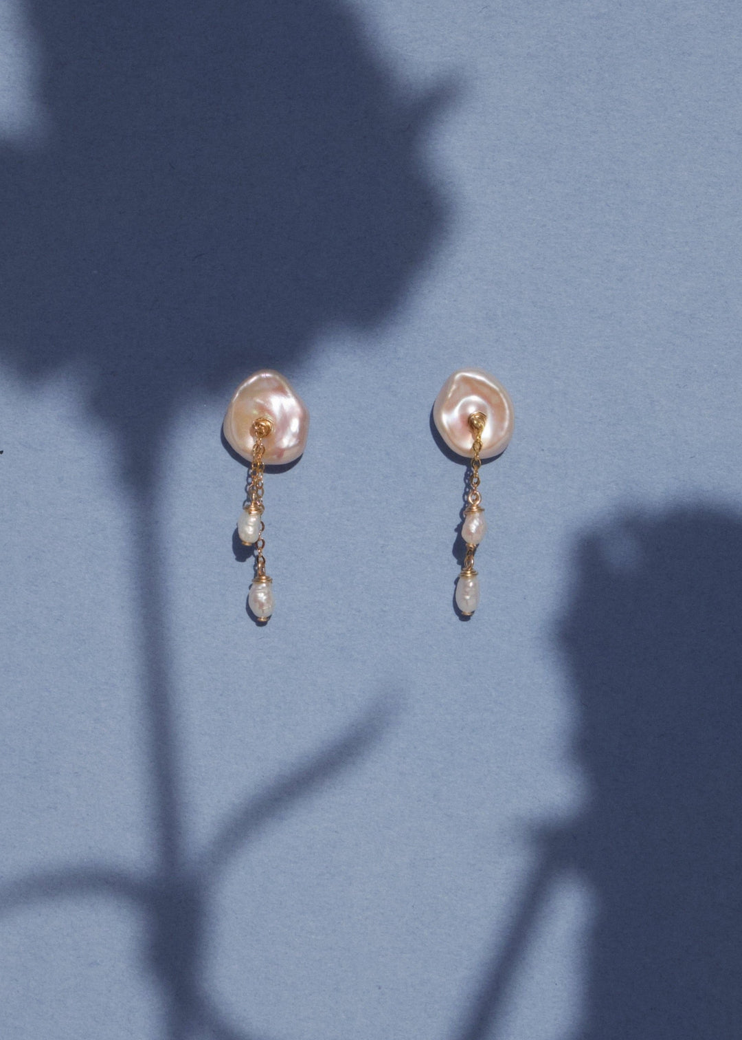A keshi pearl earrings with solid gold chains and dangling pearls