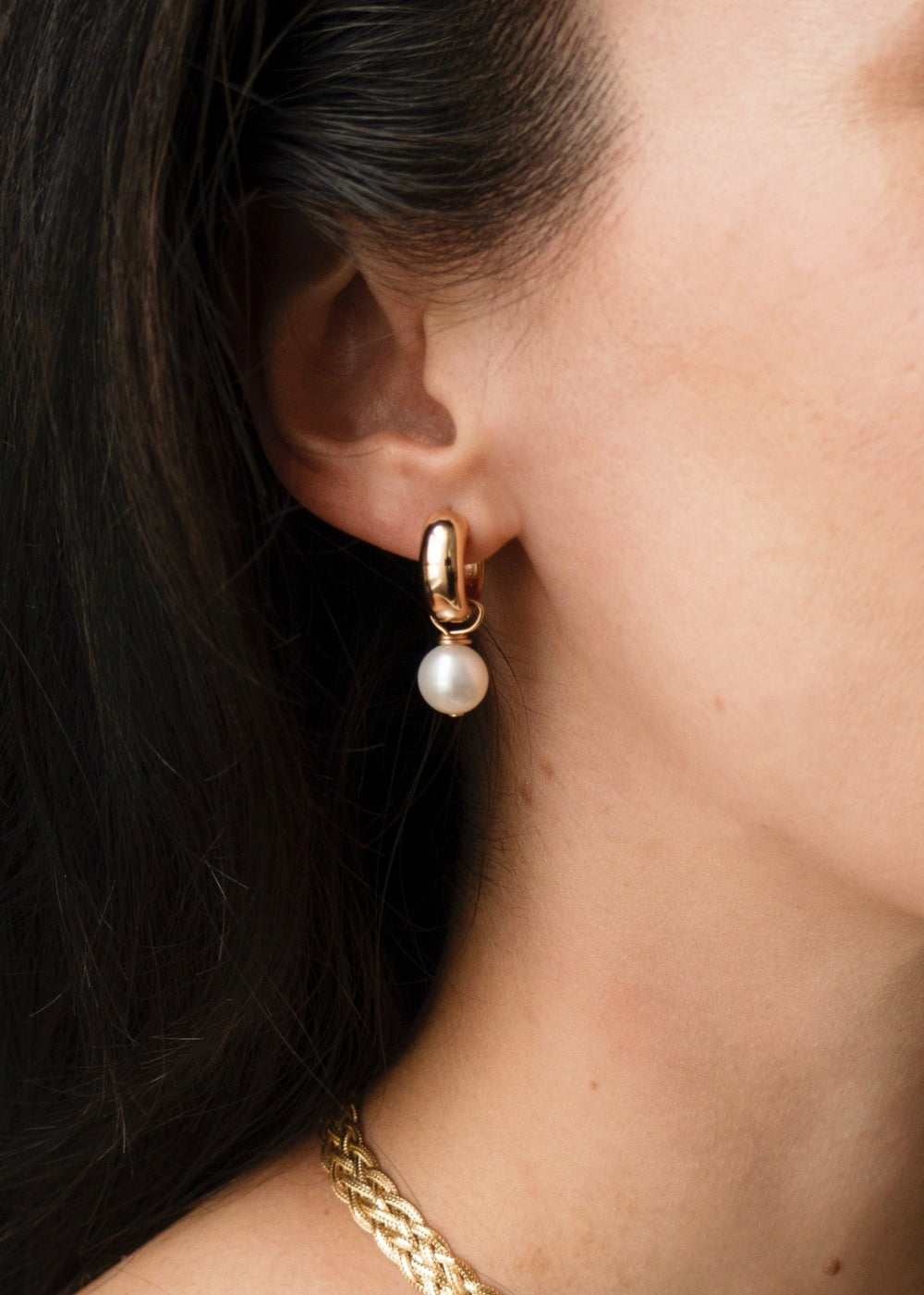 Earrings with gold-filled hoops and a small pearl