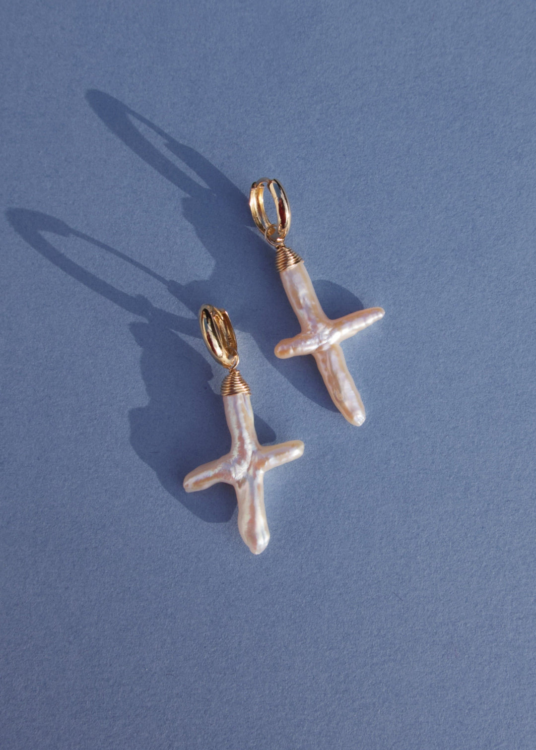 14K Gloria Earrings - Made with baroque pearl crosses, our Gloria Earrings are a unique and elegant look. These earrings will remain a beloved accessory for years to come. 14K Solid Gold Tarnish-Resistant & Hypoallergenic AAA Grade Genuine Freshwater Pear