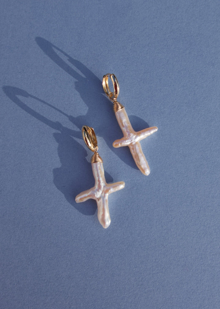 14K Gloria Earrings - Made with baroque pearl crosses, our Gloria Earrings are a unique and elegant look. These earrings will remain a beloved accessory for years to come. 14K Solid Gold Tarnish-Resistant & Hypoallergenic AAA Grade Genuine Freshwater Pear