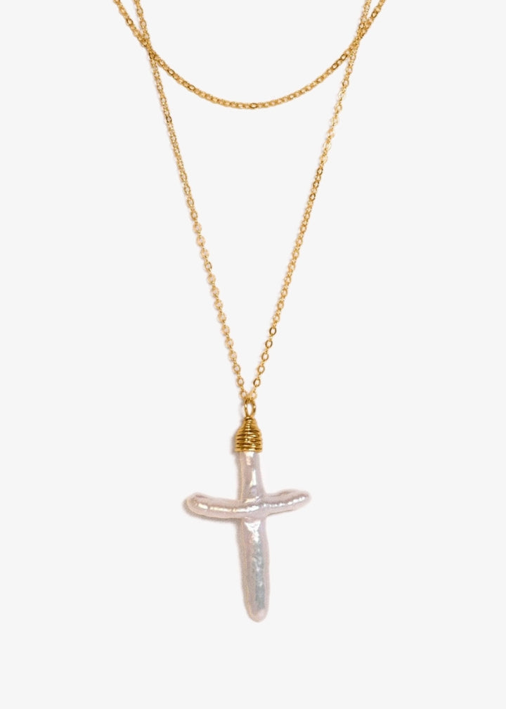 Gloria Pearl Cross - Made with a baroque pearl cross, our Gloria necklace is a new take on an old classic. Now is the perfect time to switch out your gold cross for a dainty pearl one. 14K Gold-Filled or Sterling Silver Tarnish-Resistant & Hypoallergenic