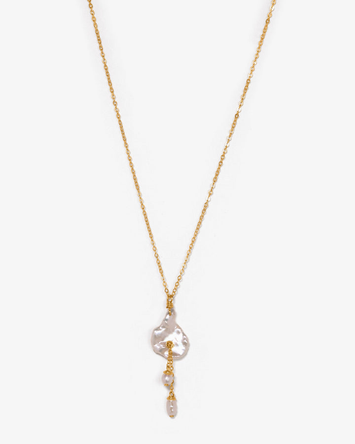 14K Lily Necklace - This dainty necklace is our sweet playful take on a calla lily. Simple enough to wear to work and fancy enough to wear to a wedding, you will struggle taking this beauty off. It&