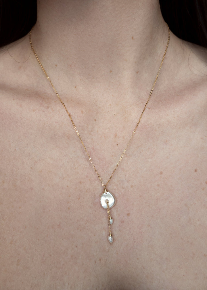 14K Lily Necklace - This dainty necklace is our sweet playful take on a calla lily. Simple enough to wear to work and fancy enough to wear to a wedding, you will struggle taking this beauty off. It&
