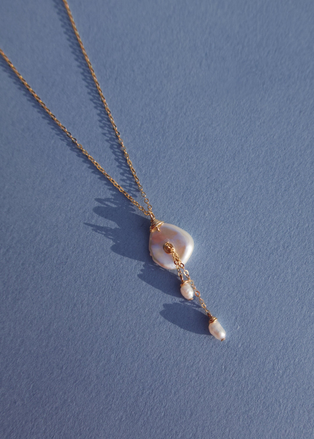14K Lily Necklace - This dainty necklace is our sweet playful take on a calla lily. Simple enough to wear to work and fancy enough to wear to a wedding, you will struggle taking this beauty off. It&