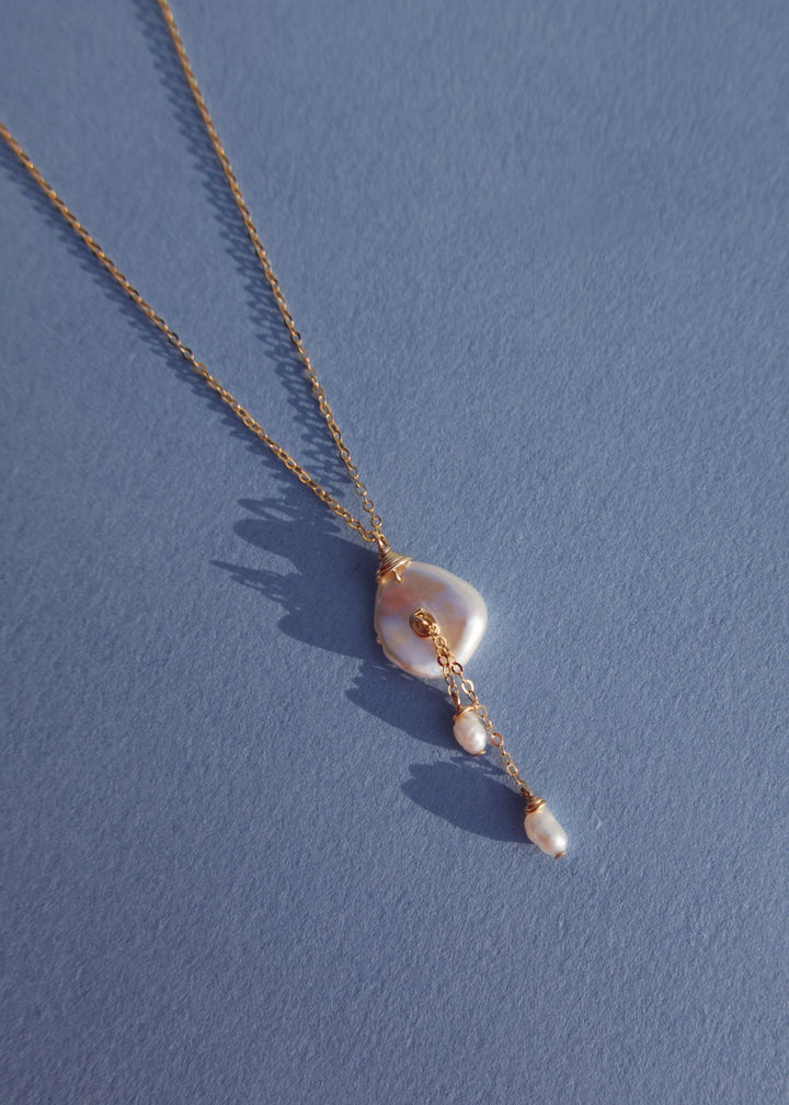 14K Lily Necklace - This dainty necklace is our sweet playful take on a calla lily. Simple enough to wear to work and fancy enough to wear to a wedding, you will struggle taking this beauty off. It&