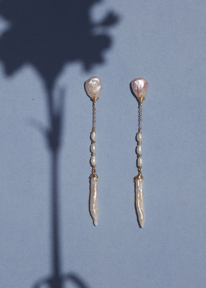 14K Nora - Effortless and light on your ears, these earrings feel unique and refreshing. Great with a white button down or paired with your favorite slip dress, these earrings are a great staple. 14K Solid Gold Tarnish-Resistant & Hypoallergenic AAA Grade