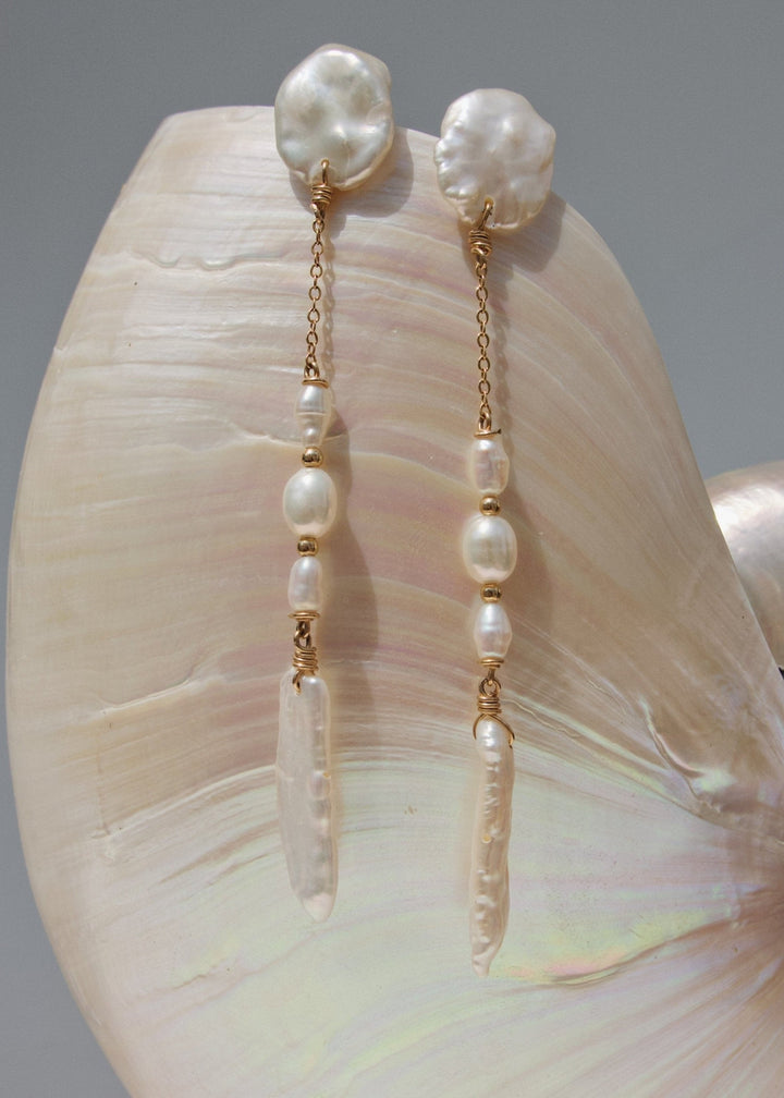14K Nora - Effortless and light on your ears, these earrings feel unique and refreshing. Great with a white button down or paired with your favorite slip dress, these earrings are a great staple. 14K Solid Gold Tarnish-Resistant & Hypoallergenic AAA Grade