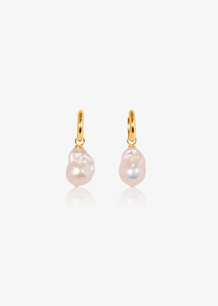 14K Sydney - Made with chunky hoops and large baroque pearls, these earrings are a jewelry box staple. 14K Solid Gold Tarnish-Resistant & Hypoallergenic AAA Grade Genuine Freshwater Pearls Handmade in NJ/NY Length 1.5" Please note - Freshwater Pearls & Ge