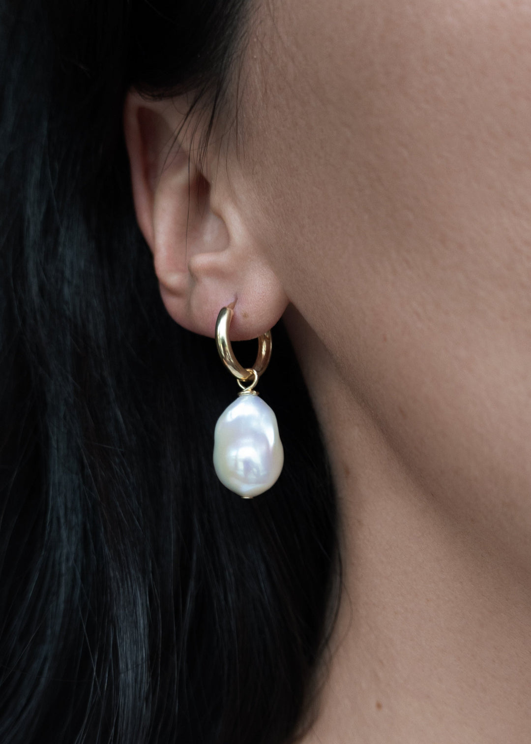 14K Sydney - Made with chunky hoops and large baroque pearls, these earrings are a jewelry box staple. 14K Solid Gold Tarnish-Resistant & Hypoallergenic AAA Grade Genuine Freshwater Pearls Handmade in NJ/NY Length 1.5" Please note - Freshwater Pearls & Ge