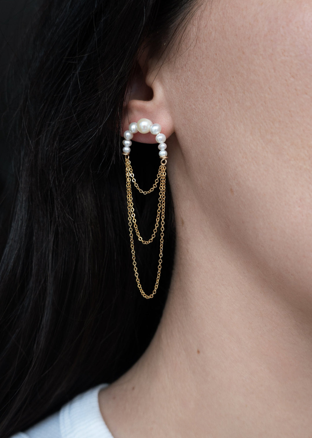 14K Valencia - Crafted with descending pearls elegantly attached to three layers of chain, these earrings create a unique silhouette that maximizes radiance. The lightweight, flowing chains add movement and charm, making them the perfect choice for dancin