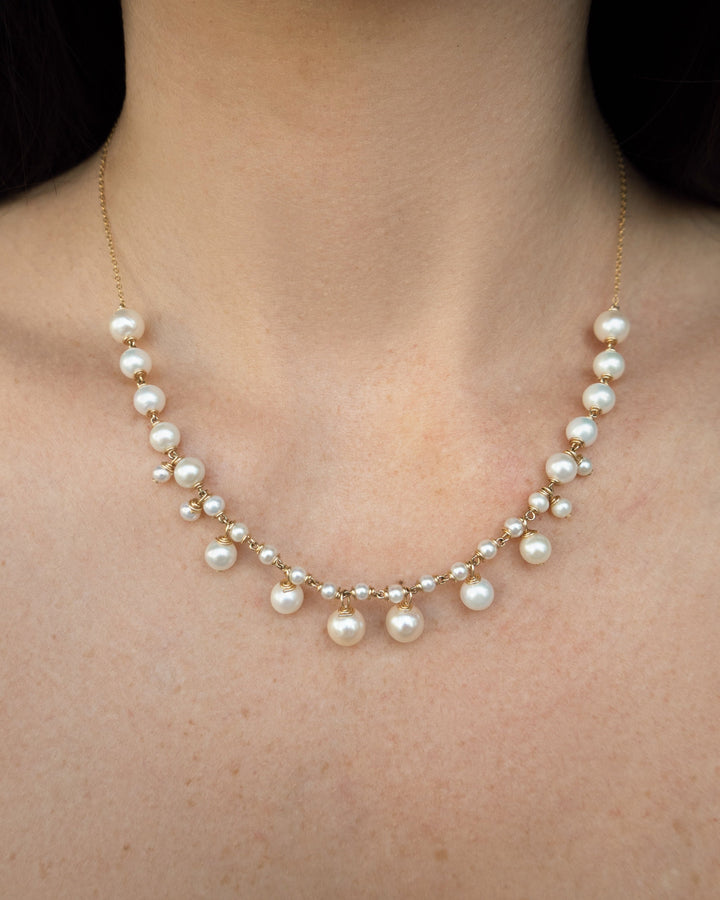 Alora - Graduated pearls flow from large to small, with delicate drops that mirror the pattern in reverse. The Alora necklace feels regal yet effortless, a modern take on classic pearl design. 14K Gold-Filled Tarnish-Resistant &amp; Hypoallergenic AAA Grade G
