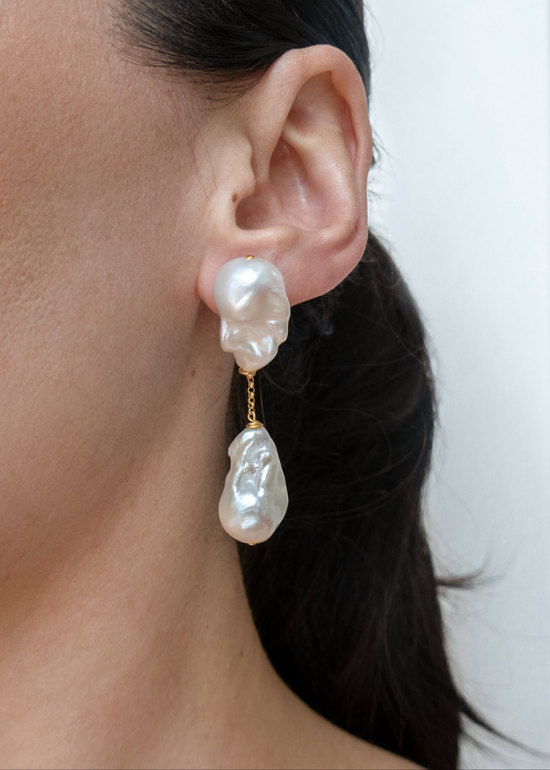 Aria earrings worn on a model&