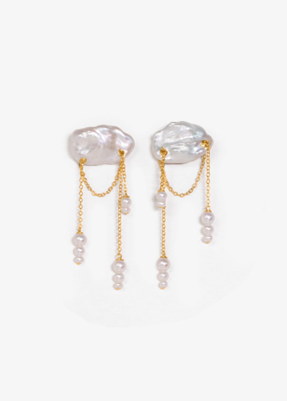 Aurora - These asymmetrical earrings feature cascading seed pearls hanging from cloud like keshi pearls. Suspended from a reflective cable chain, their unique design balances elegance and movement in a strikingly modern way. 14K Solid Gold Freshwater Kesh