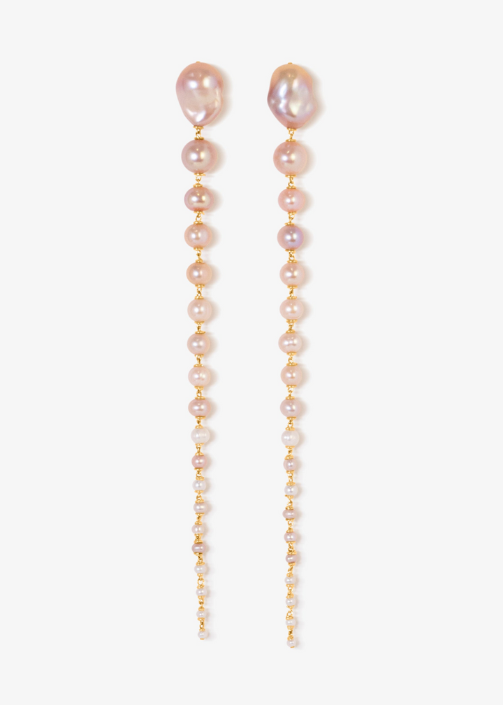Azalea - Crafted with baroque pink or white pearls that taper into delicate white seed pearls, these earrings are a bold blend of femininity and edge. Striking in every sense, they command attention with their unexpected silhouette. 14K Gold-Filled Tarnis