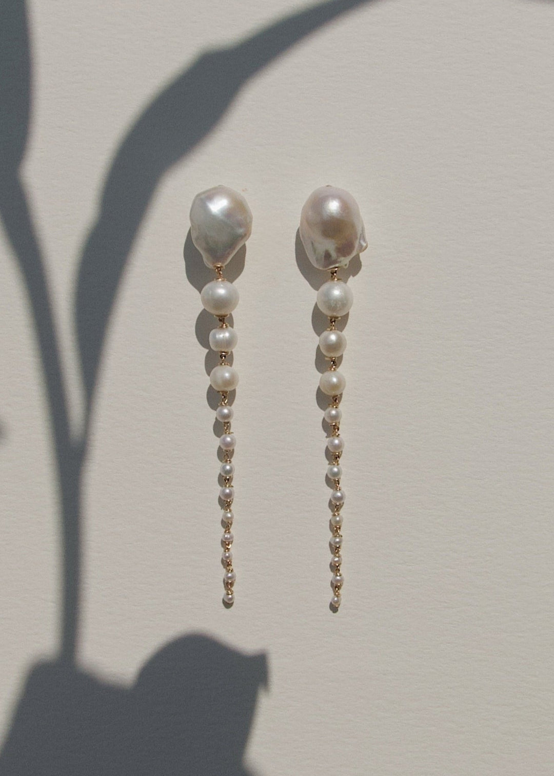 Azalea Petite - A more delicate take on a dramatic favorite. This petite version features baroque white pearls that taper into fine white seed pearls, creating a softer silhouette that still catches the eye. Refined and romantic, with just enough edge to
