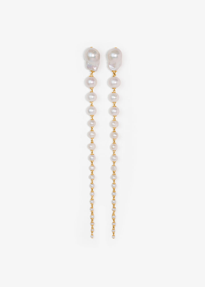 Pair of pearl and gold chain earrings on a white background