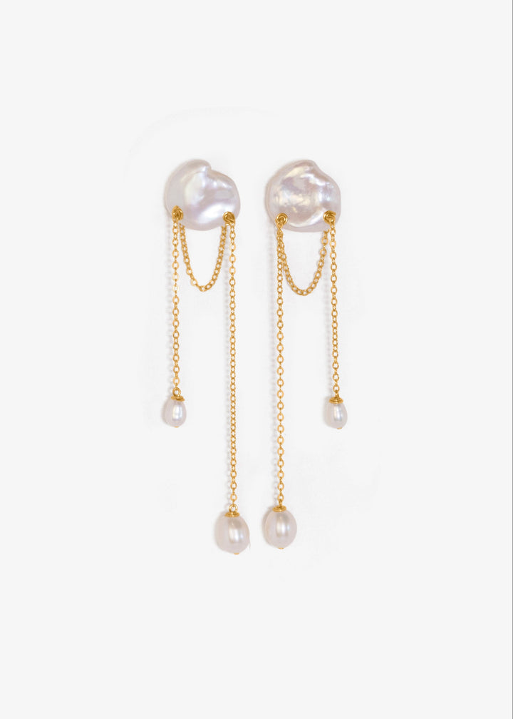 Bria - A single keshi pearl anchors this delicate design, with two fine strands falling at varied lengths. Between them, a single gold chain is draped like a quiet detail you almost missed. Graceful and understated, it’s a perfect choice for a wedding or