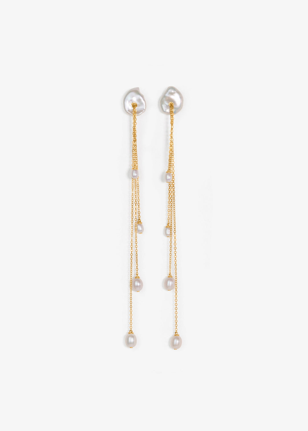 Calla - A more dramatic take on our beloved Lily earrings. Four delicate strands of chain fall at varying lengths, each finished with a glowing teardrop pearl that catches the light with every movement. They’re long, refined, and impossibly dainty. Design