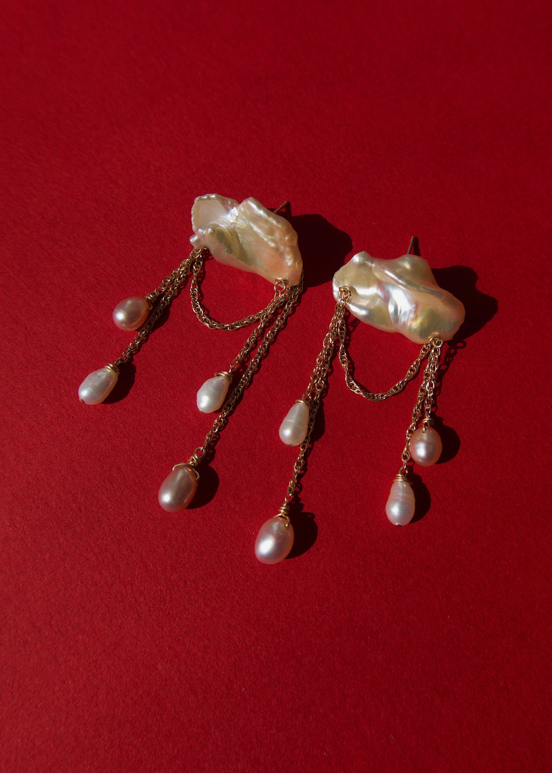 Stunning earrings featuring keshi and baroque pearls with gold chain