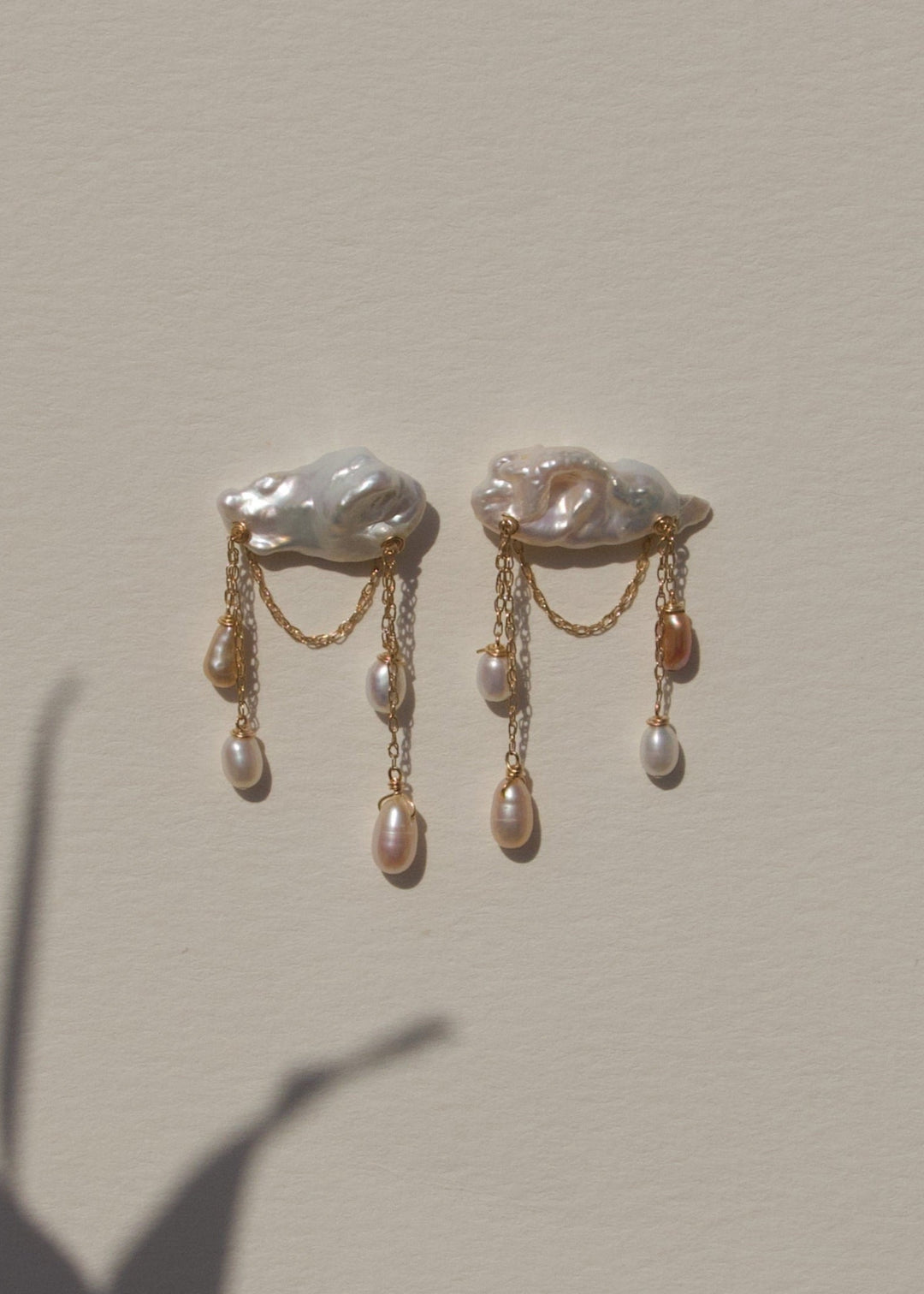Stunning earrings featuring keshi and baroque pearls with gold chain