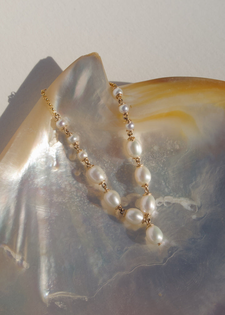 Celene Bracelet - Six teardrop pearls and one dangling center pearl create a soft, cascading look that transitions into delicate seed pearls. Elegant and eye-catching, the Selene stands beautifully on its own. 14K Gold-Filled Metals Tarnish-Resistant & Hy
