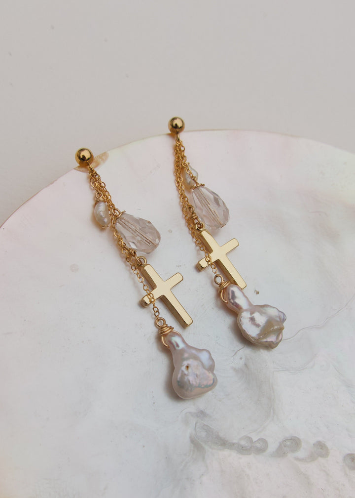 Earrings adorned with gold cross, glass beads and baroque pearls