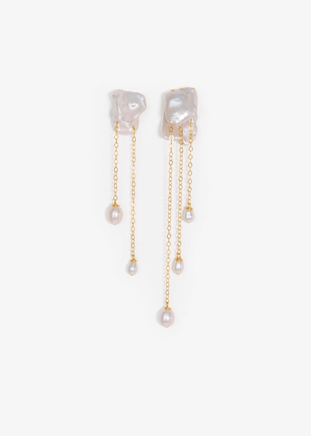 Cleo - Crafted in solid 14k gold, the Cleo earrings feel like wearable sculpture. Two folded keshi pearls create a soft, organic form, each one unique in shape and texture. From their folds, gold chains cascade down, ending in glowing teardrop pearls that
