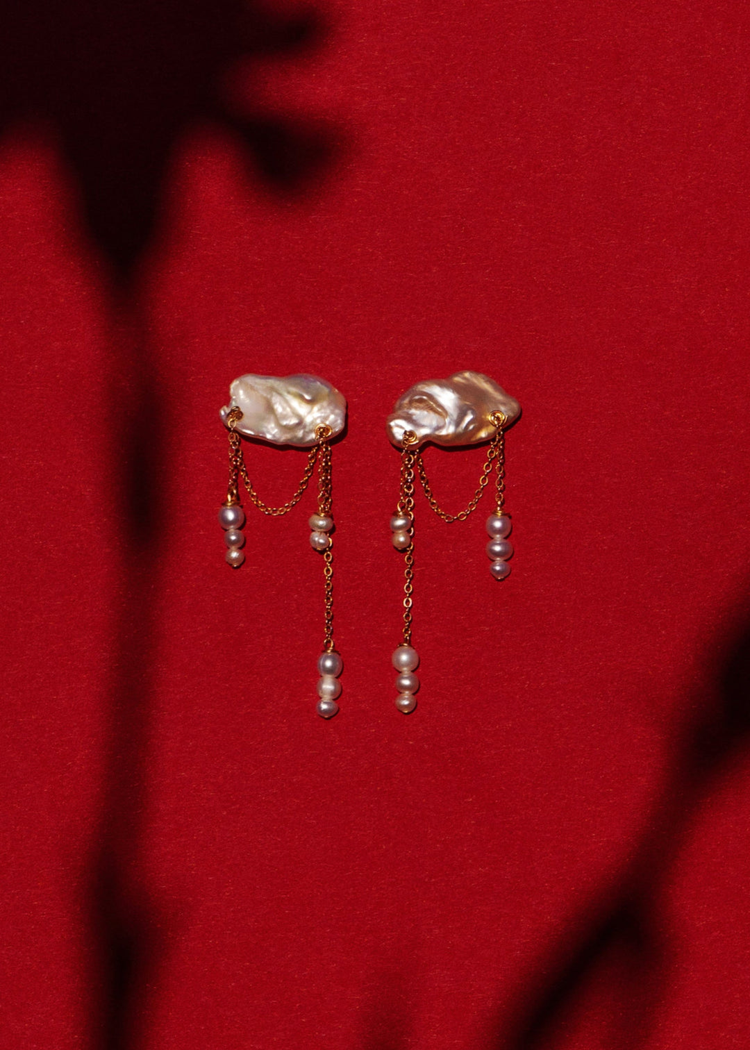 Solid gold earrings with a keshi pearl and dangling seed pearls