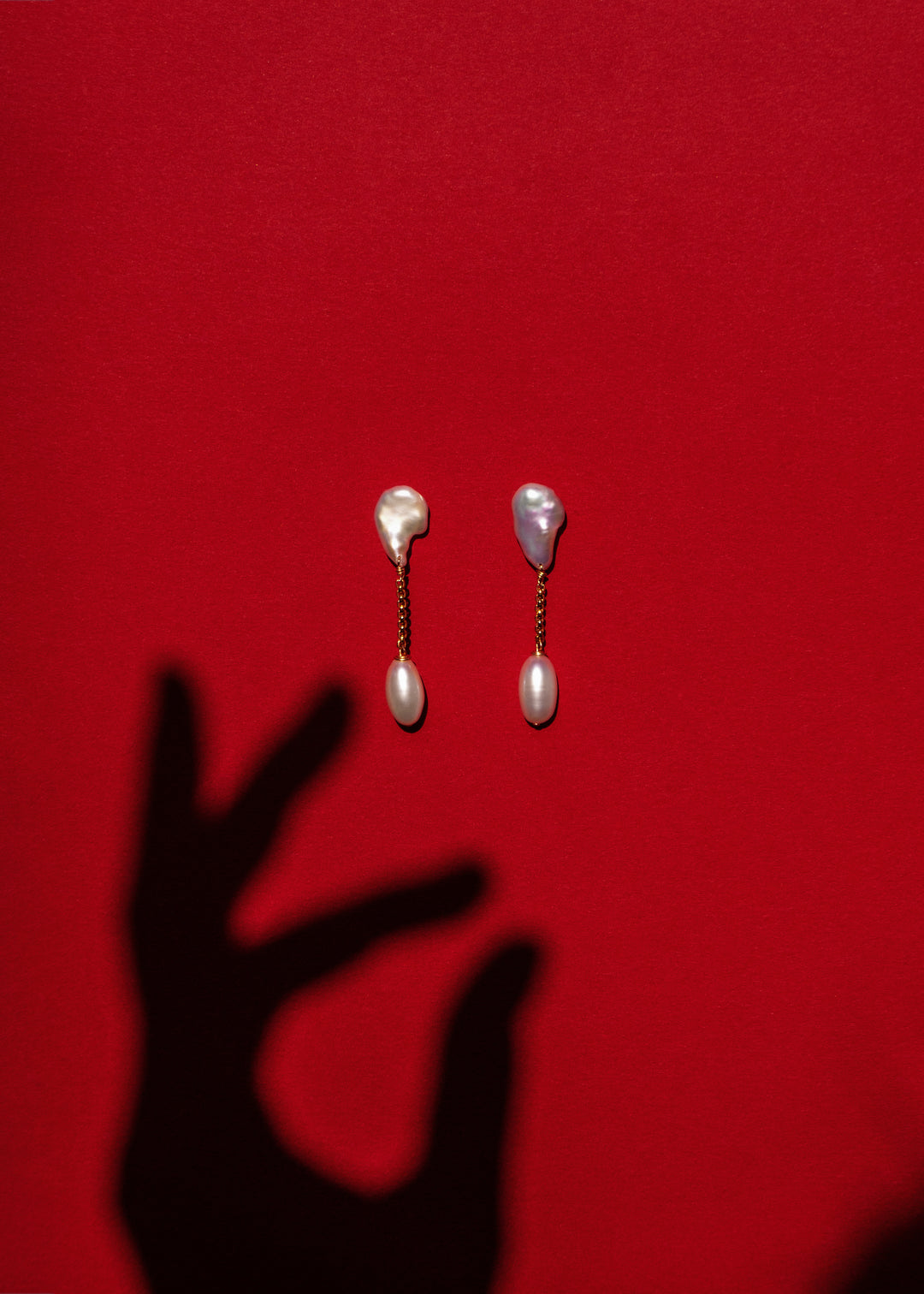 Solid gold earrings with a keshi and a teardrop pearl