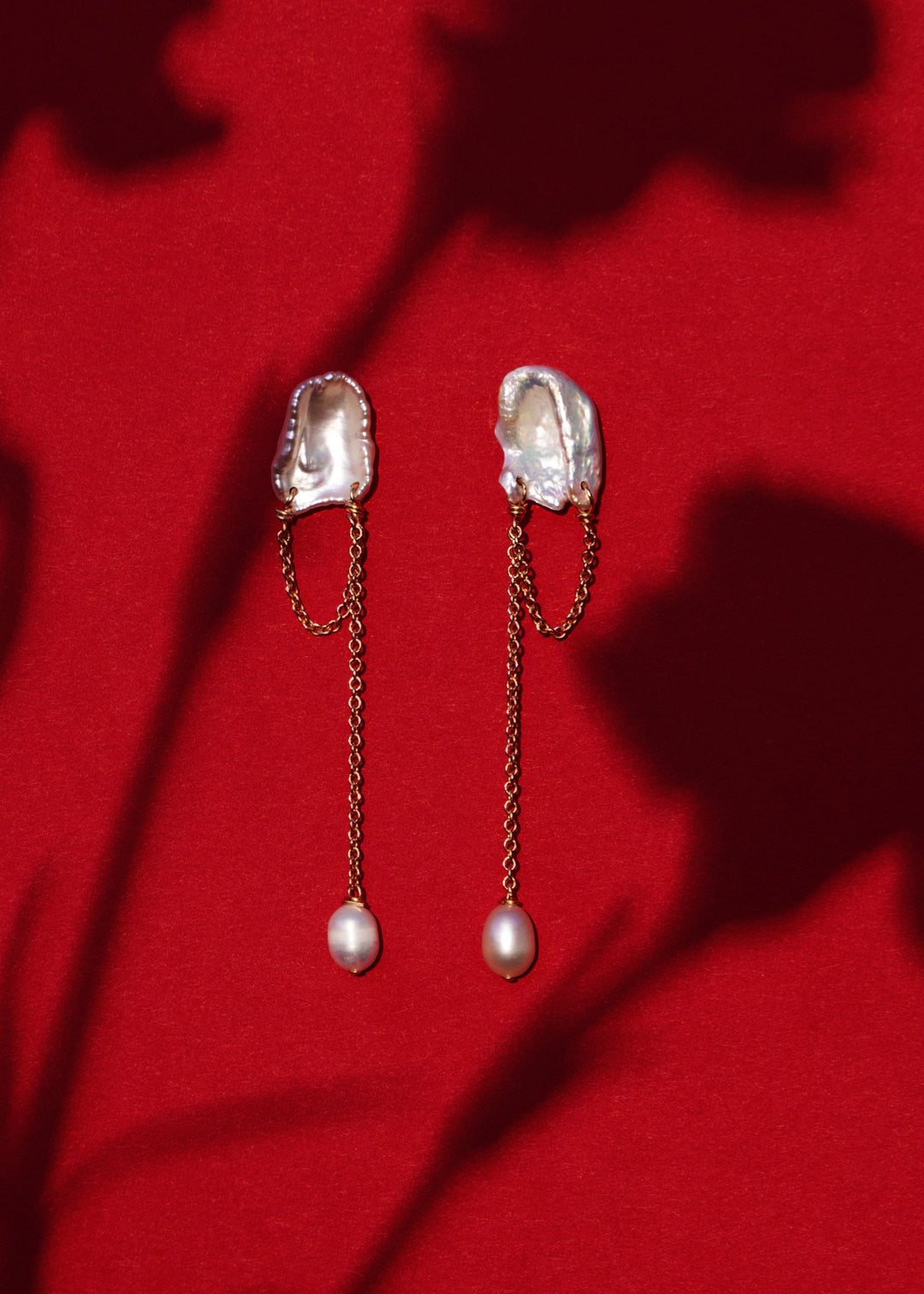 Solid gold earrings with a keshi pearl and a dangling teardrop pearl