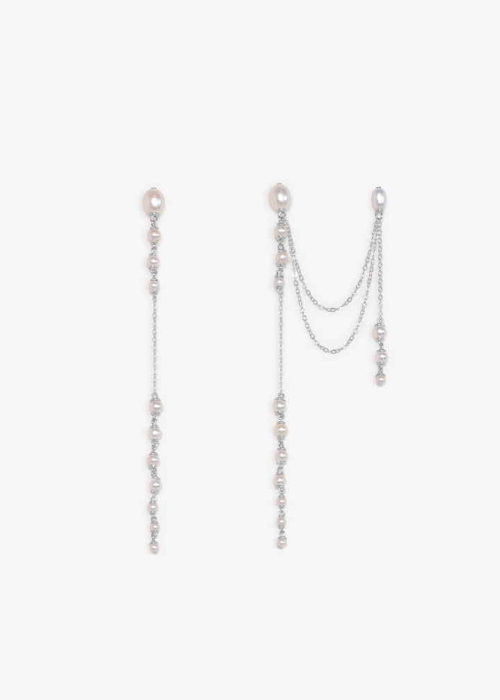 Dahlia - A gentle cascade of seed pearls creates a tapering effect that feels almost weightless. Designed to drape across two piercings the silhouette is delicate, but far from simple. Each pearl moves with quiet intention, catching the light like raindro