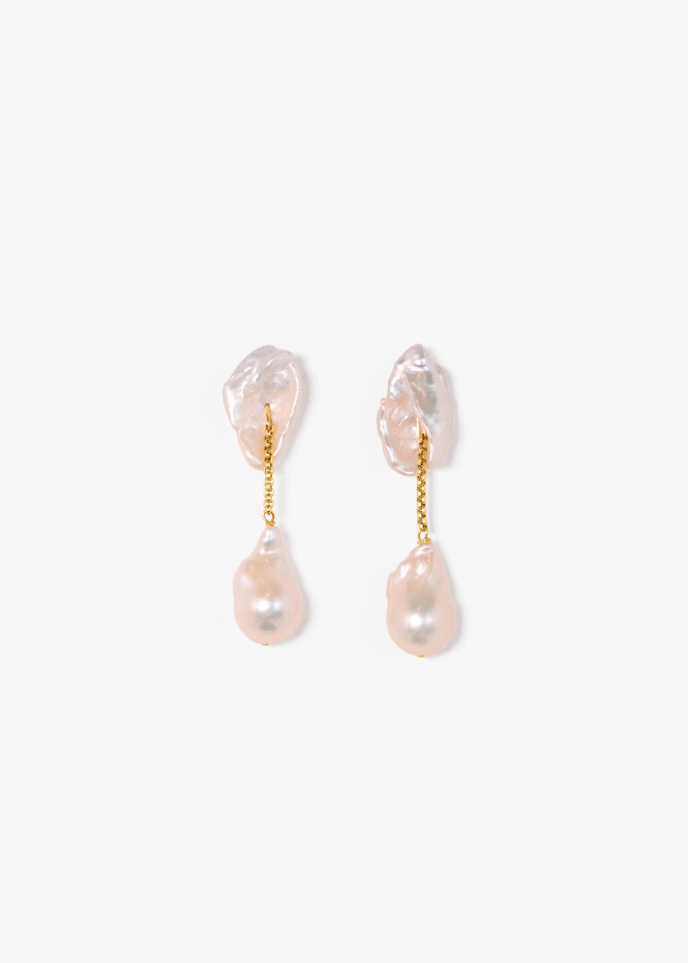 Dessa - These earrings feature two large keshi pearls shaped like conch shells, offering a unique and textured focal point. Suspended from a sleek round box chain, a large baroque pearl hangs at the end, creating a stunning contrast of organic shapes and