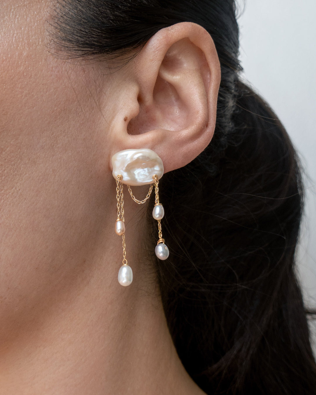 Dove earrings worn on a model's ear