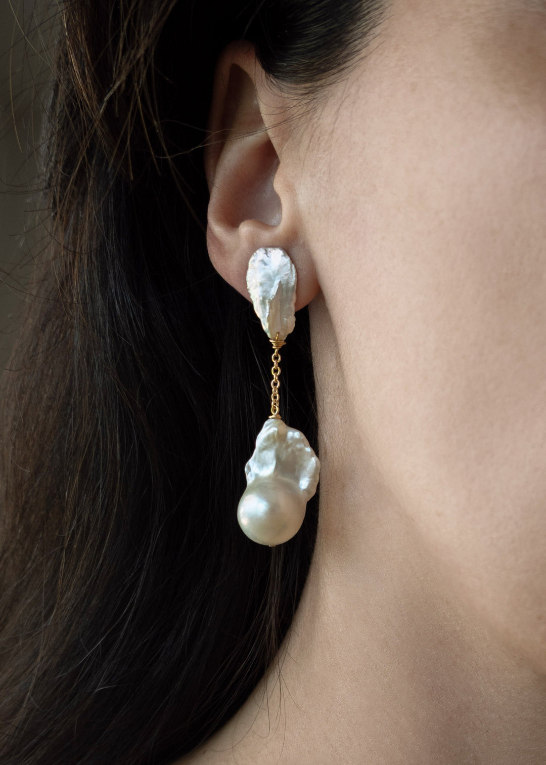 Fiora - These earrings feature sharp, angular keshi pearls with rugged, sculptural shapes that command attention. From a substantial chain, two large fireball pearls hang gracefully, creating a striking and bold silhouette. 14K Solid Gold Freshwater Baroq