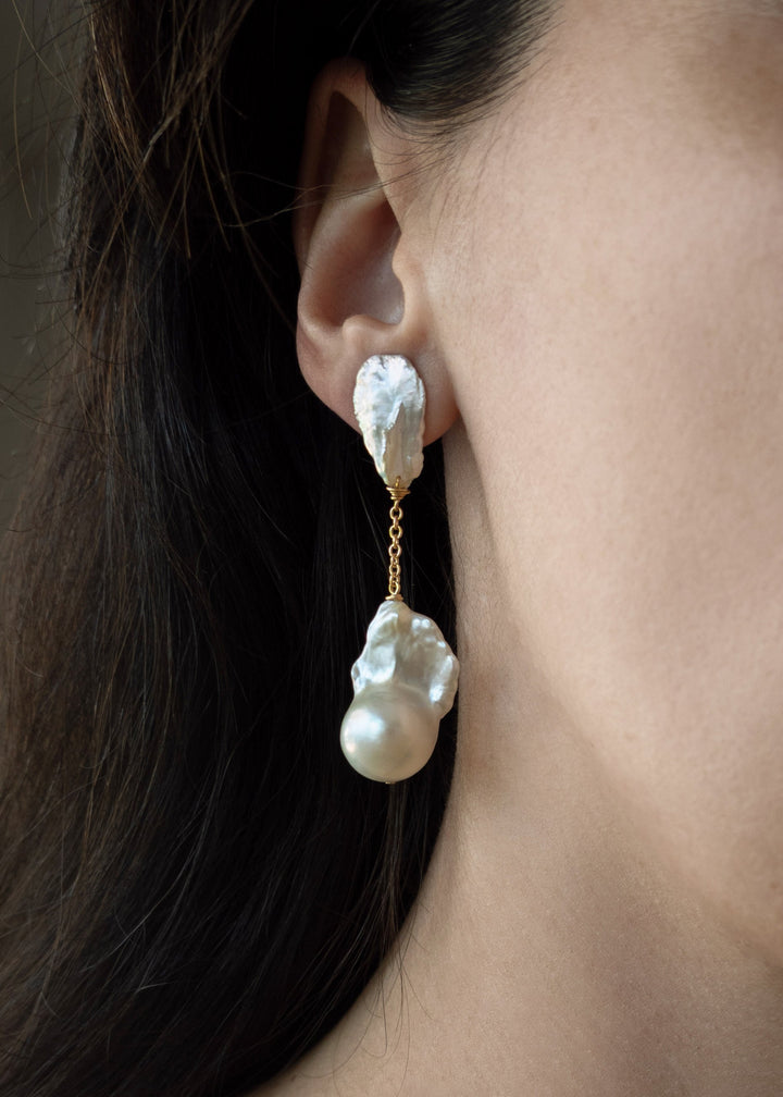 Fiora - These earrings feature sharp, angular keshi pearls with rugged, sculptural shapes that command attention. From a substantial chain, two large fireball pearls hang gracefully, creating a striking and bold silhouette. 14K Solid Gold Freshwater Baroq