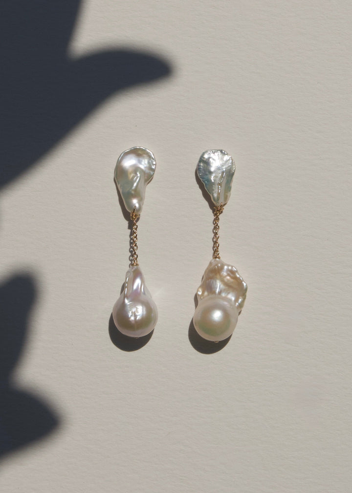 Fiora - These earrings feature sharp, angular keshi pearls with rugged, sculptural shapes that command attention. From a substantial chain, two large fireball pearls hang gracefully, creating a striking and bold silhouette. 14K Solid Gold Freshwater Baroq