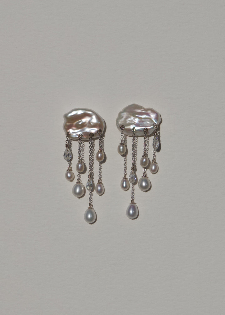 Front view of Halo earrings with white keshi pearl tops, cascading white teardrop pearls and diamonds on fine 14k white gold chains.