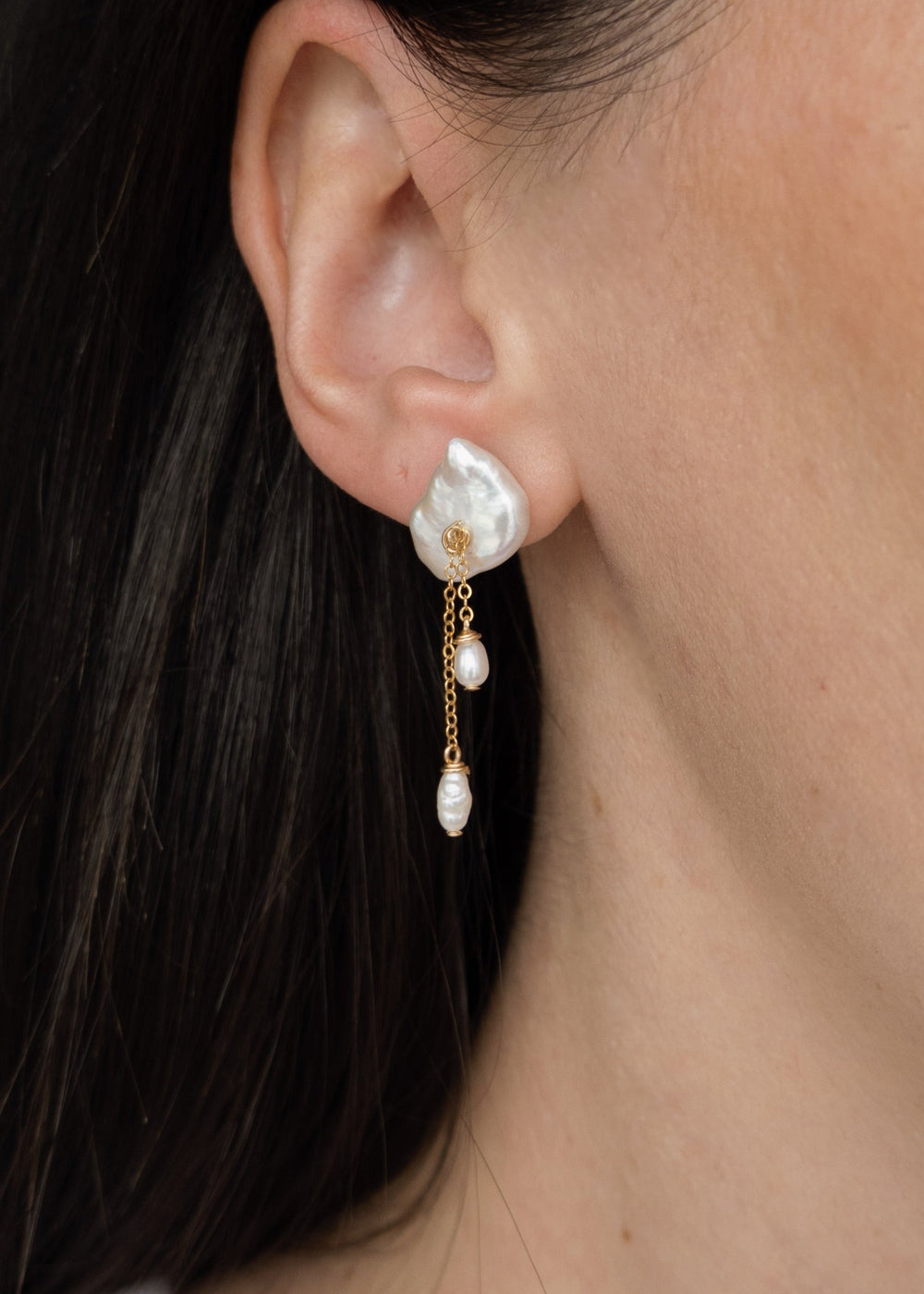 A keshi pearl earring with gold-filled chains and dangling pearl