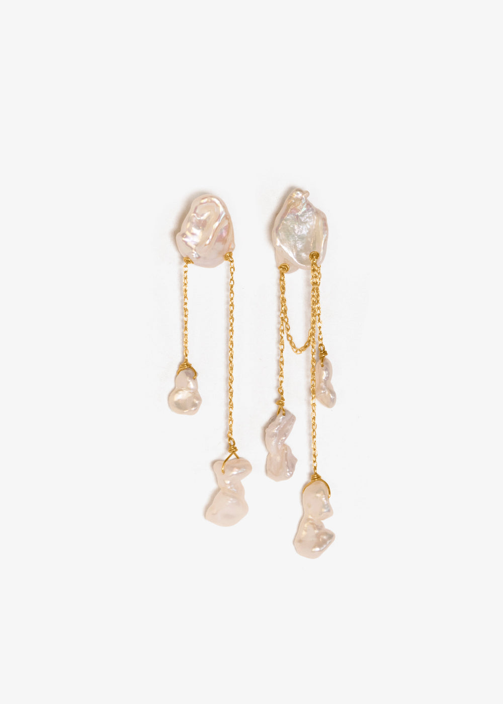 Pair of gold earrings with clear stones on a white background