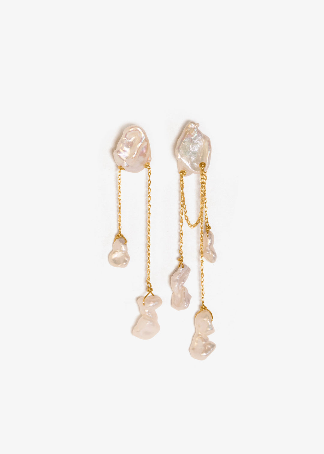 Pair of gold earrings with clear stones on a white background