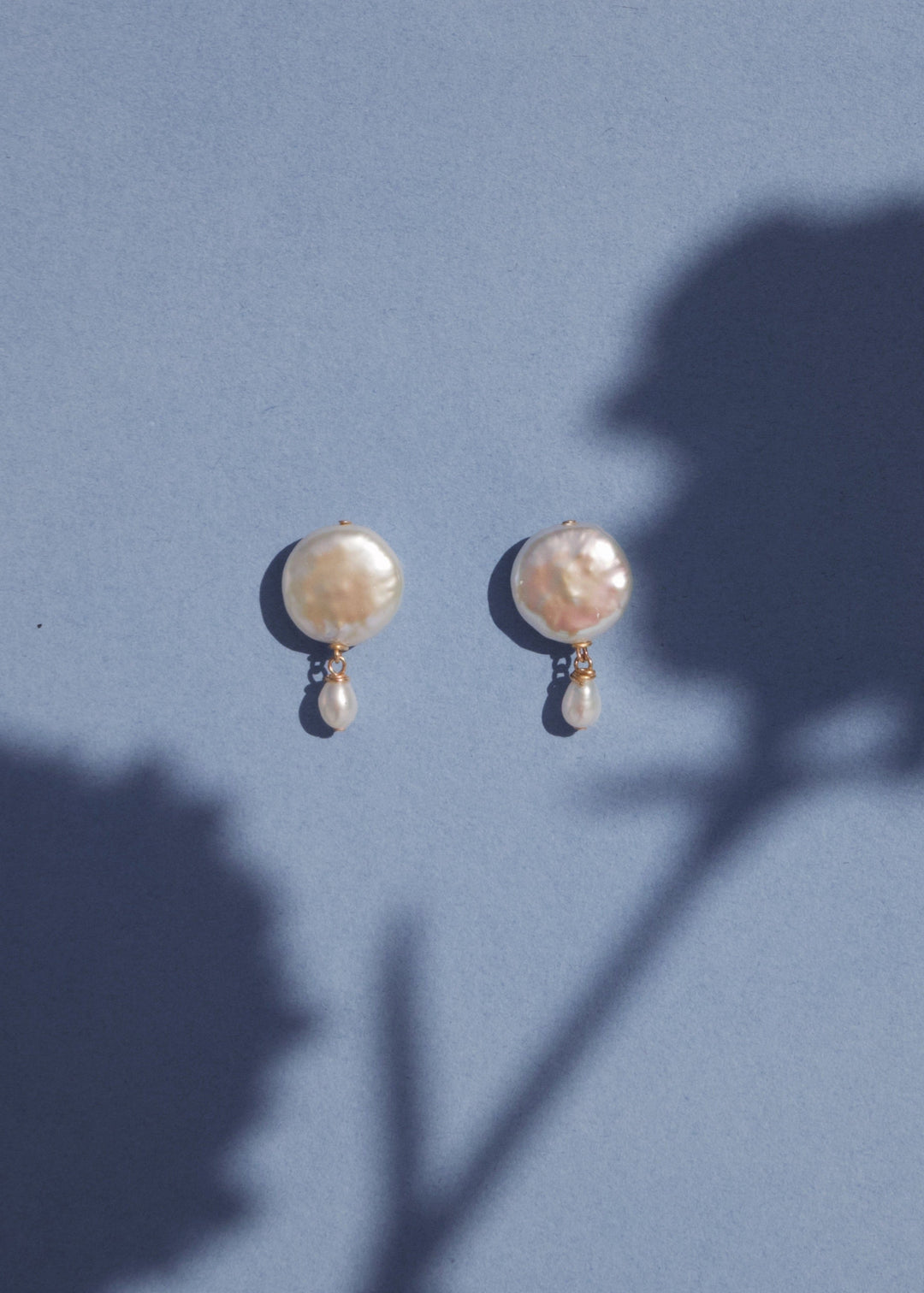 Solid gold mini earrings with a white coin pearl and a dainty pearl