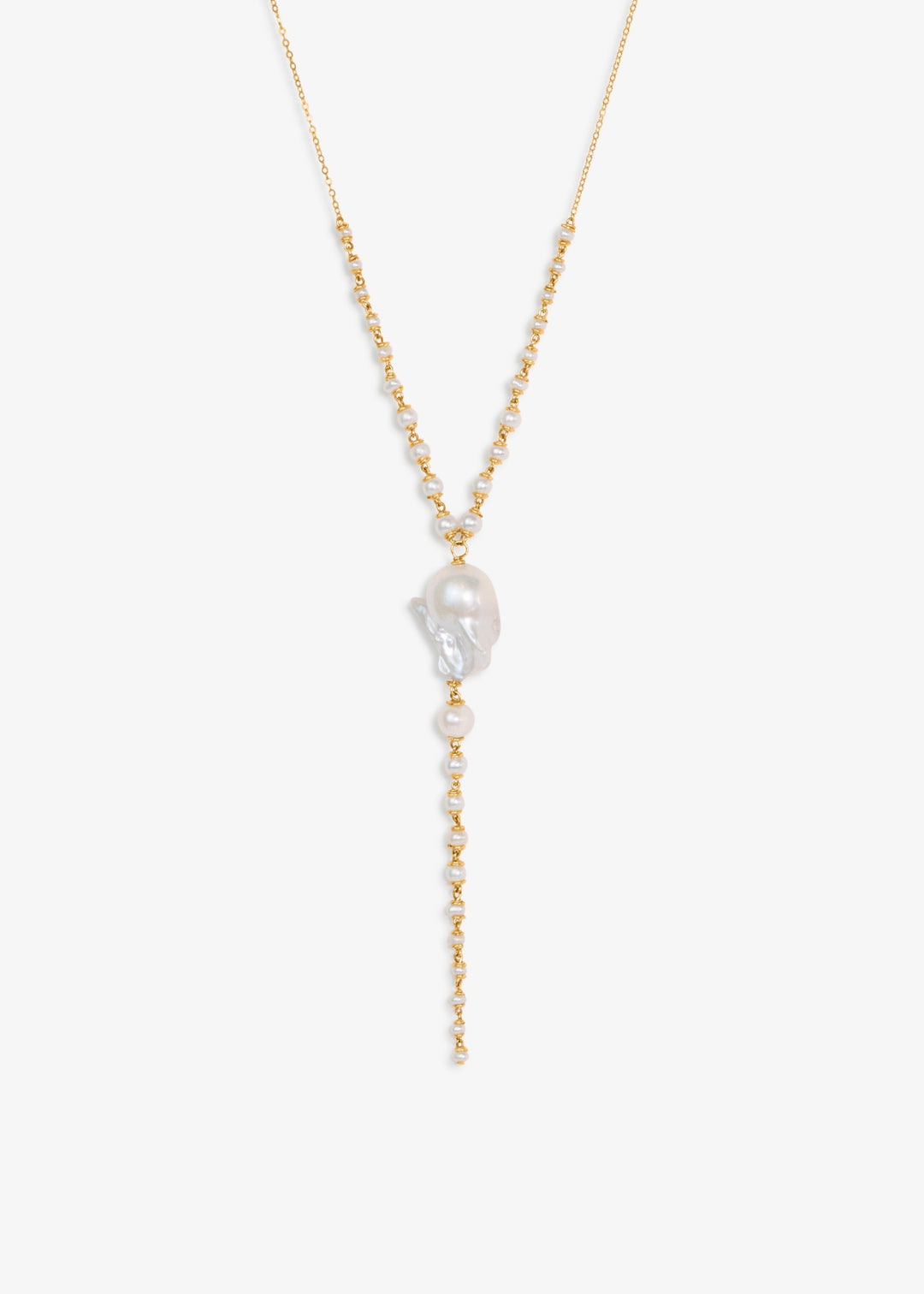 Mira - This lariat necklace is all about balance between structure and softness, simplicity and detail. A luminous baroque pearl anchors the center, framed by three strands of seed pearls that taper gently in size. They meet a delicate chain that adds jus