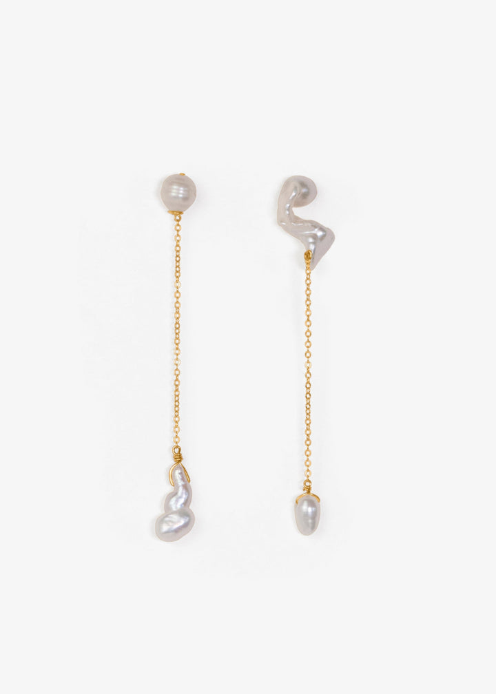 Nova - These asymmetrical earrings feature a crescent-shaped pearl on one side, evoking the delicate curve of the moon. Dainty chains hang from each end, with a teardrop pearl dangling at the bottom, creating an elegant design that balances softness and c