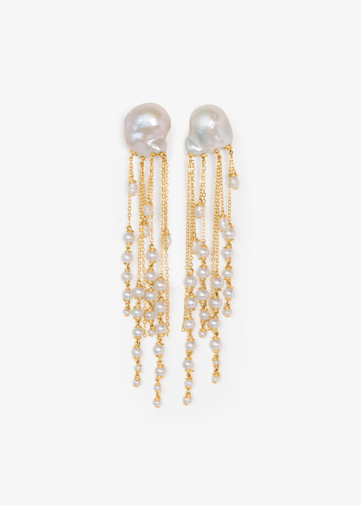 Opal - There’s a rhythm to these earrings. Fluid and mesmerizing, like the pull of the ocean. Eight strands of seed pearls taper gently downward, floating alongside draped gold chains that shimmer with every step. At nearly four inches long, they’re bold