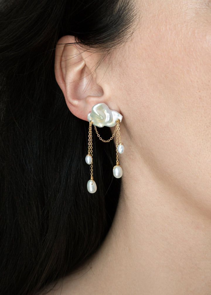 Opaline - These asymmetrical earrings showcase eight glowing teardrop pearls paired with sculptural keshi pearls for a strikingly unique silhouette. Set on a highly reflective cable chain, they blend fluidity and boldness in perfect harmony. 14K Solid Gol