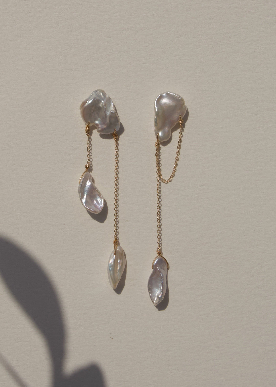 Solid gold earrings with different shaped keshi pearls
