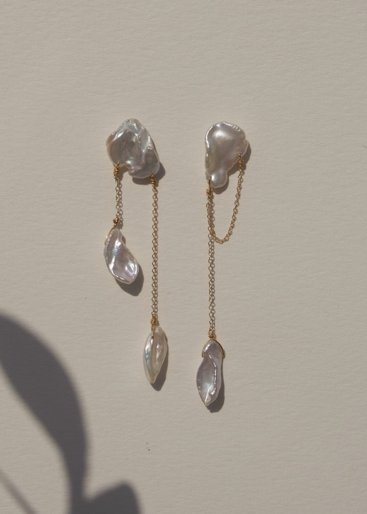 Solid gold earrings with different shaped keshi pearls
