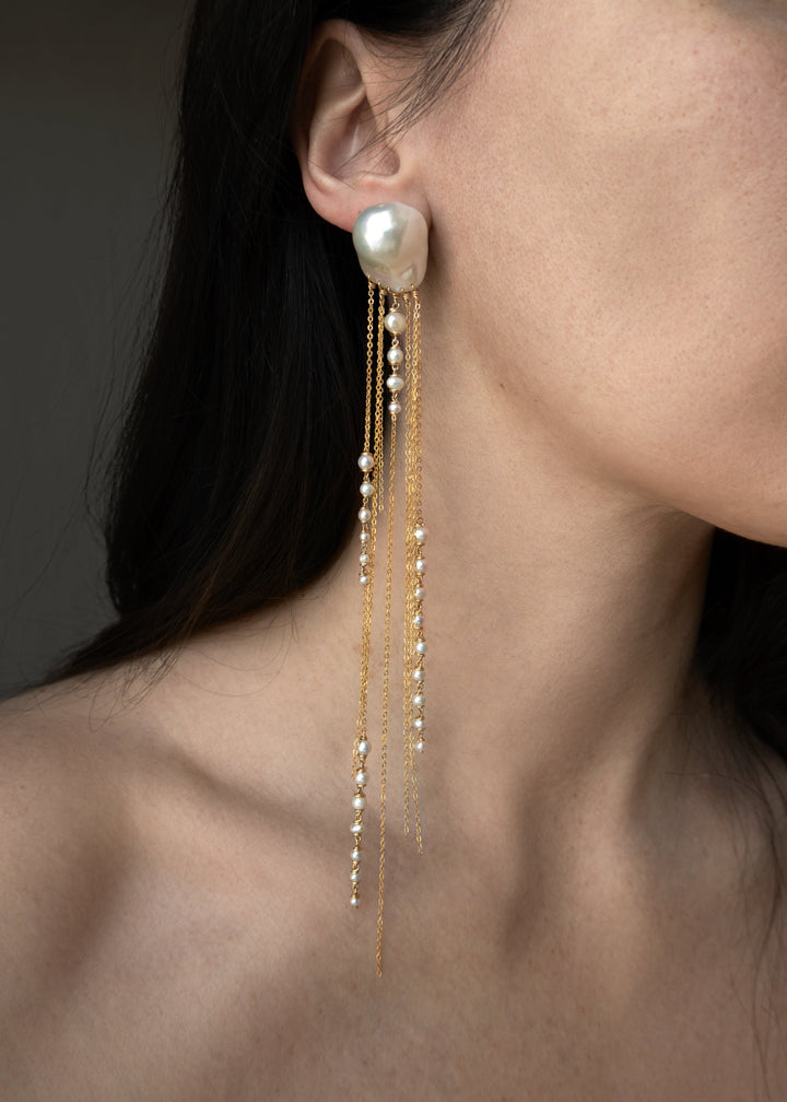 Phoria - Inspired by the fluid motion of a jellyfish drifting in ocean waves, these earrings dazzle with every movement. The chain catches and reflects the light, creating a mesmerizing effect. Long, dramatic, and impossible to ignore, they’re designed to