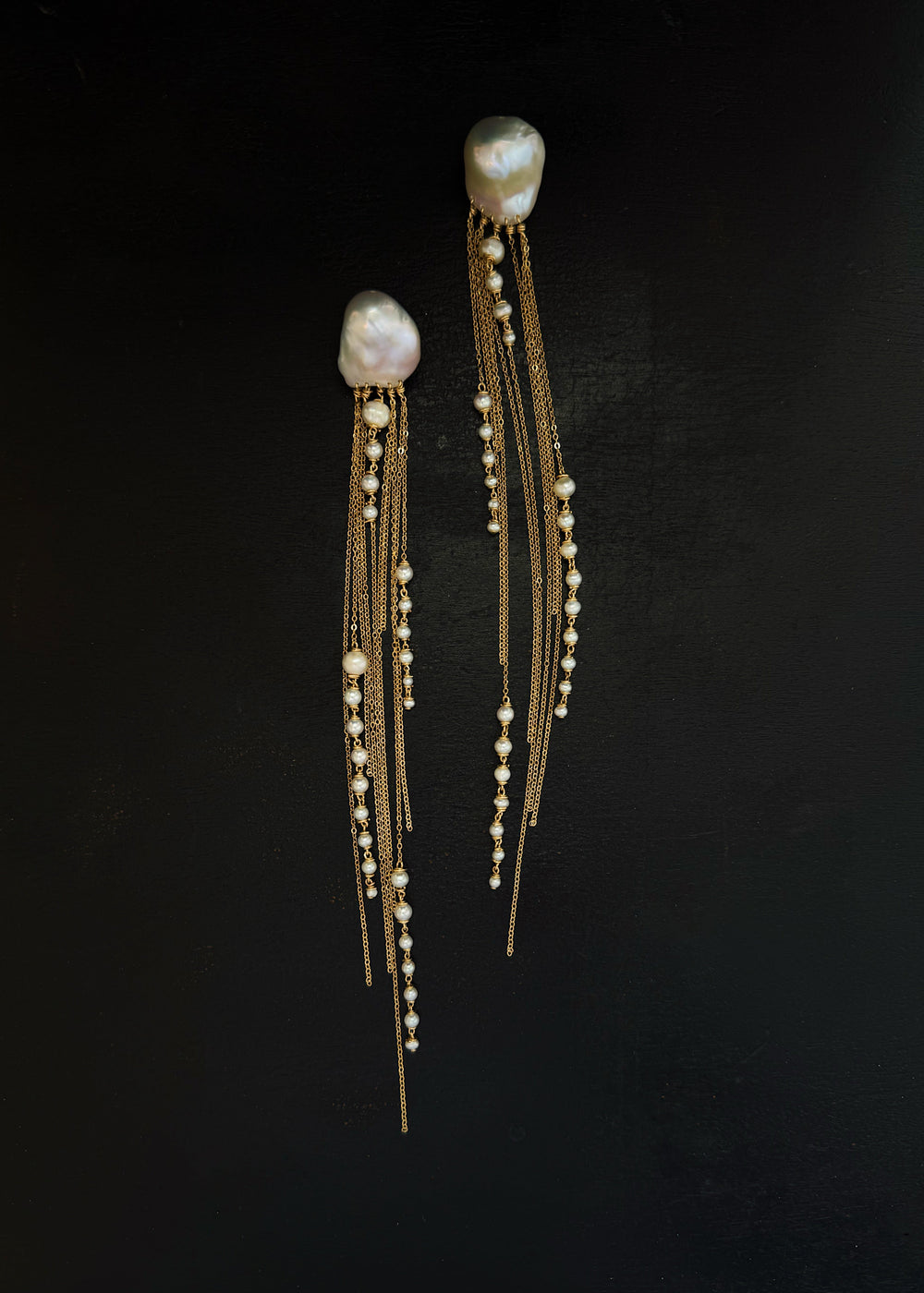 Phoria - Inspired by the fluid motion of a jellyfish drifting in ocean waves, these earrings dazzle with every movement. The chain catches and reflects the light, creating a mesmerizing effect. Long, dramatic, and impossible to ignore, they’re designed to