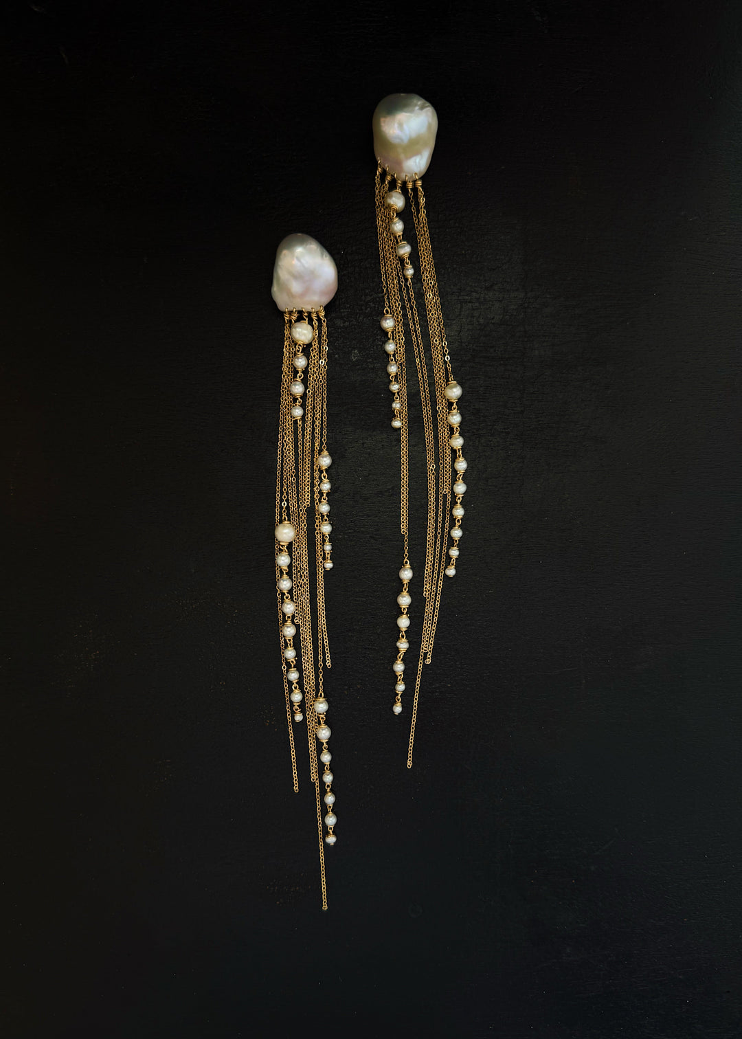 Phoria - Inspired by the fluid motion of a jellyfish drifting in ocean waves, these earrings dazzle with every movement. The chain catches and reflects the light, creating a mesmerizing effect. Long, dramatic, and impossible to ignore, they’re designed to